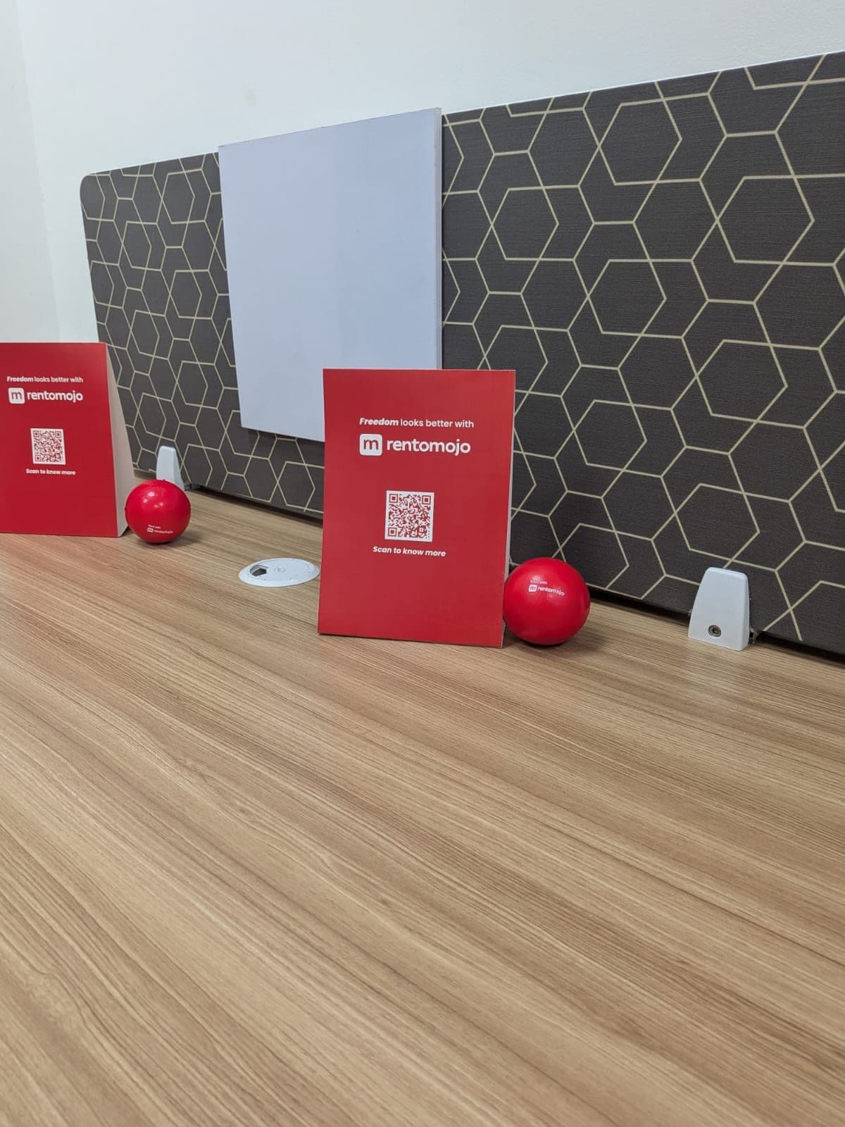 RentoMojo-branded stress balls and Freedom looks better with RentoMojo desk cards placed at corporate workstations