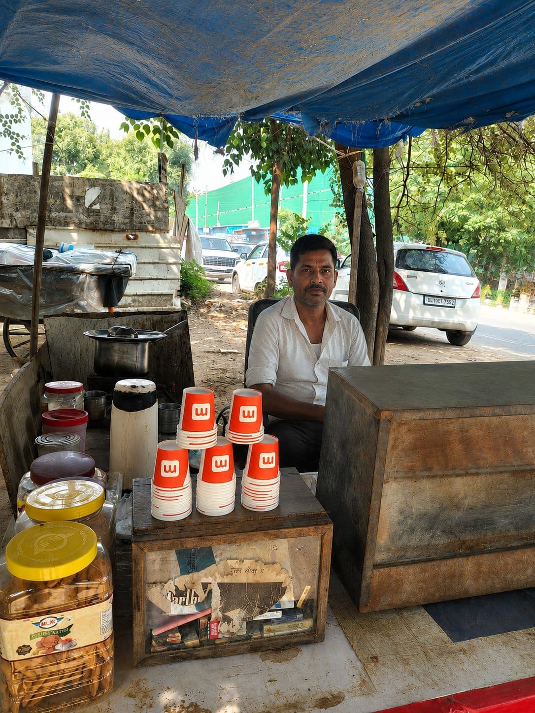 Street tapri vendor serving from a RentoMojo-branded counter outside a Delhi NCR corporate office