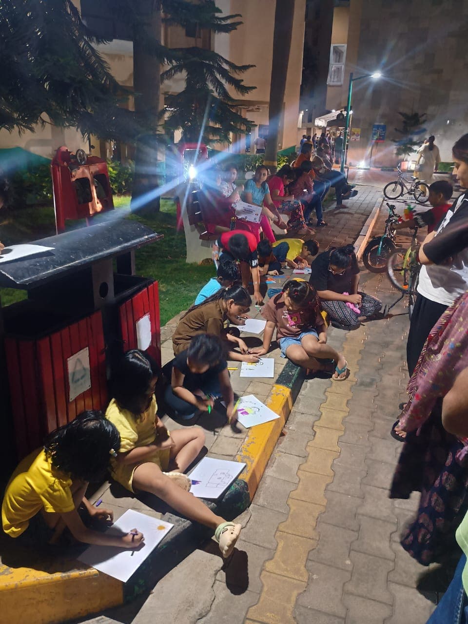 Children drawing their favourite story characters at a Wippi RWA drawing camp after dark