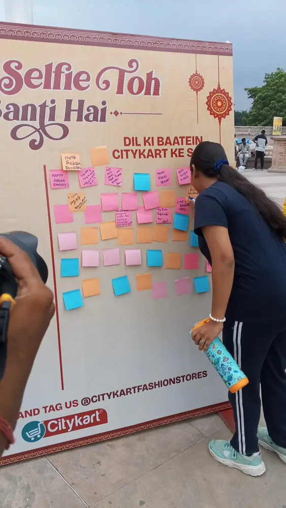 A visitor adding a wish to the Citykart selfie wall, part of the festive activation in Lucknow