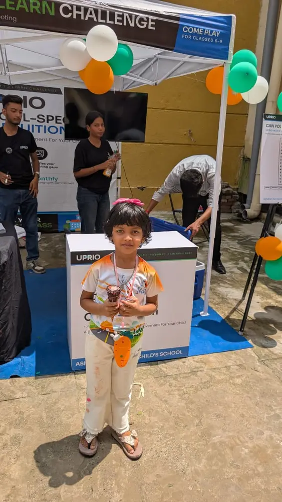 A child at the UPRIO Freedom to Learn Challenge stall during the Delhi activation