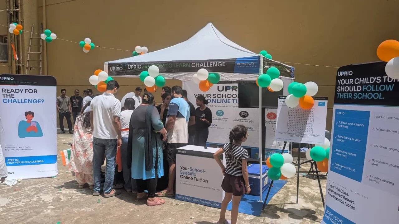 UPRIO Freedom to Learn Challenge tent with tricolour balloons, banners and a crowd of children and parents at the EdTech activation in Delhi