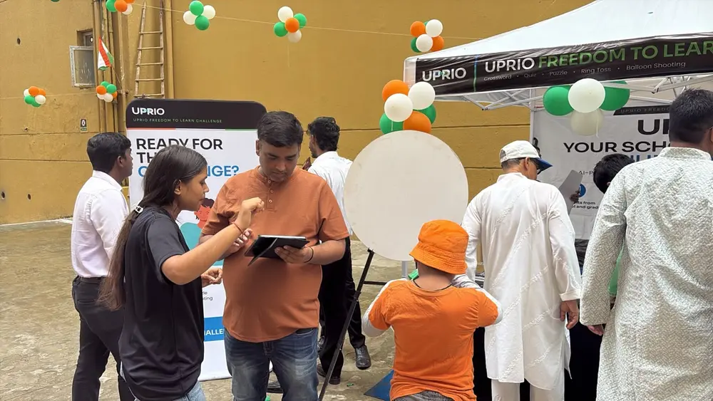 UPRIO team member speaking with a parent at the Freedom to Learn Challenge stall