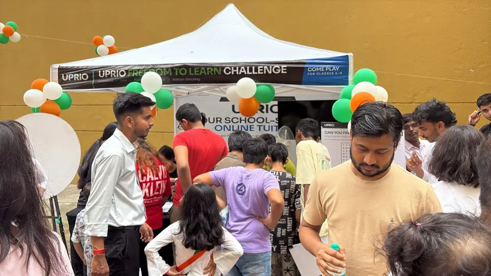 Children and parents crowding around the UPRIO tent during the game-based EdTech activation in Delhi